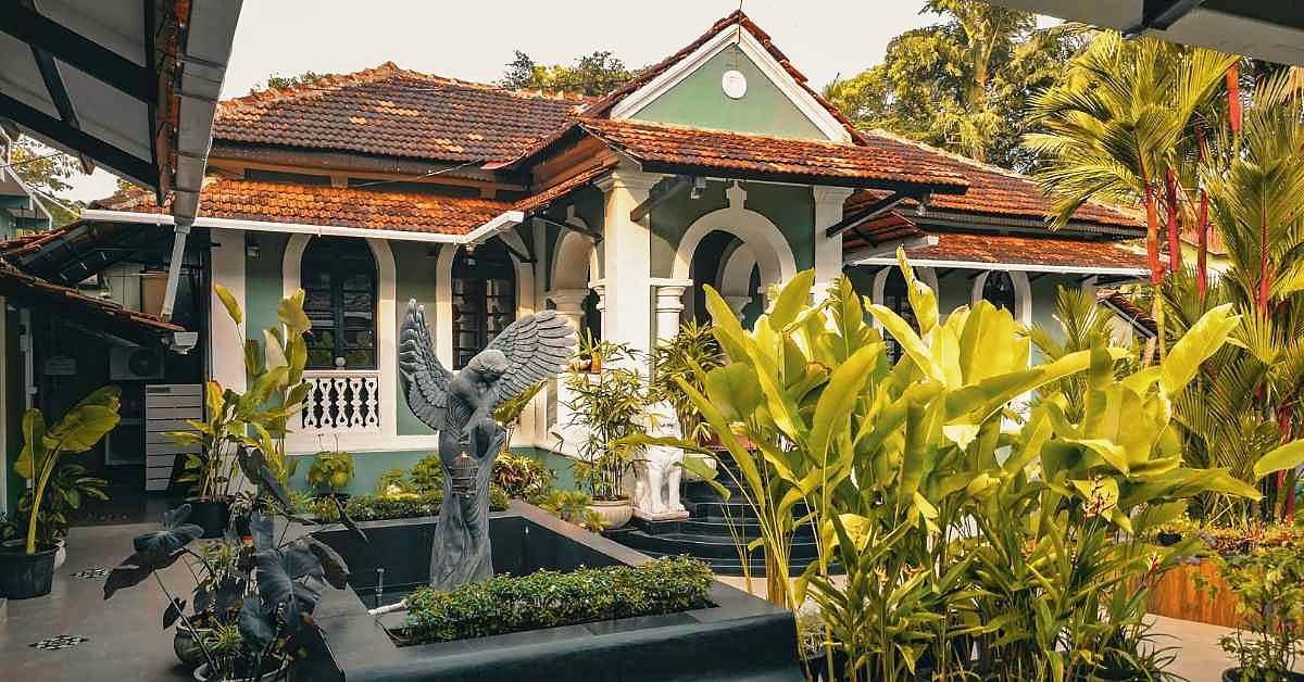 The front of a heritage bungalow behind a garden